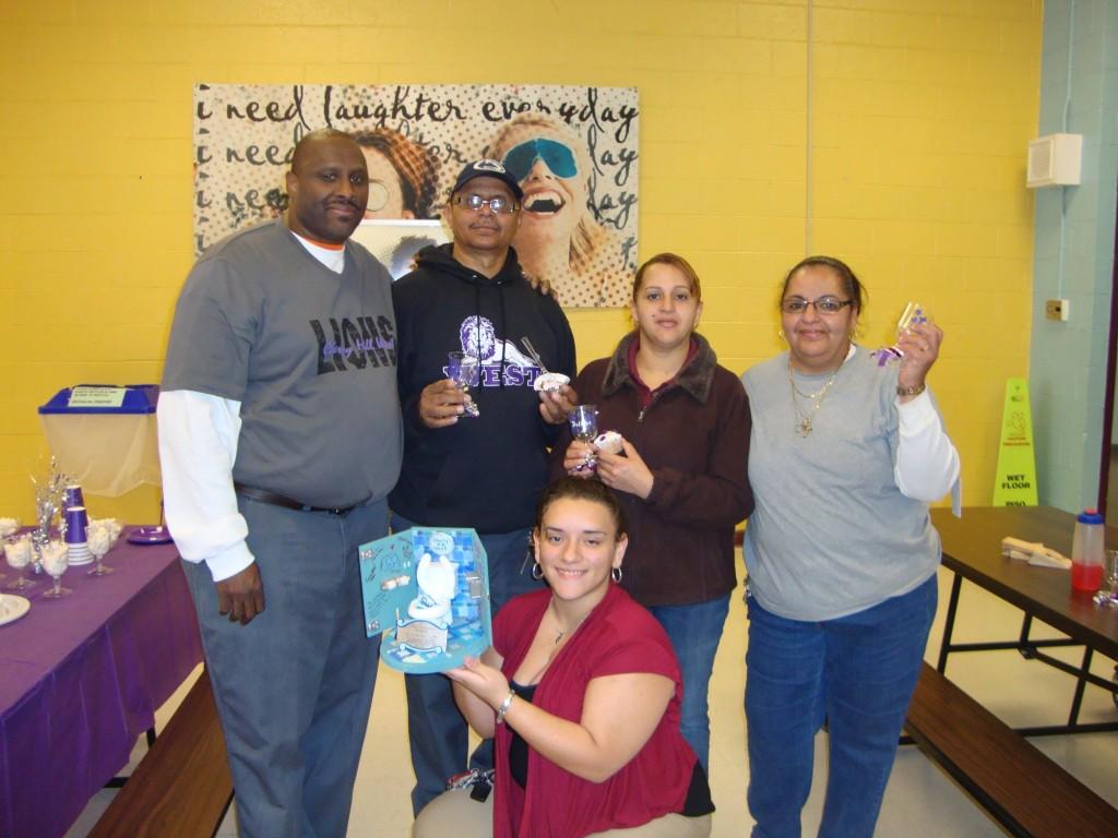 Stephanie Garcia'13 (center) presents custodians with a trophy in their honor.